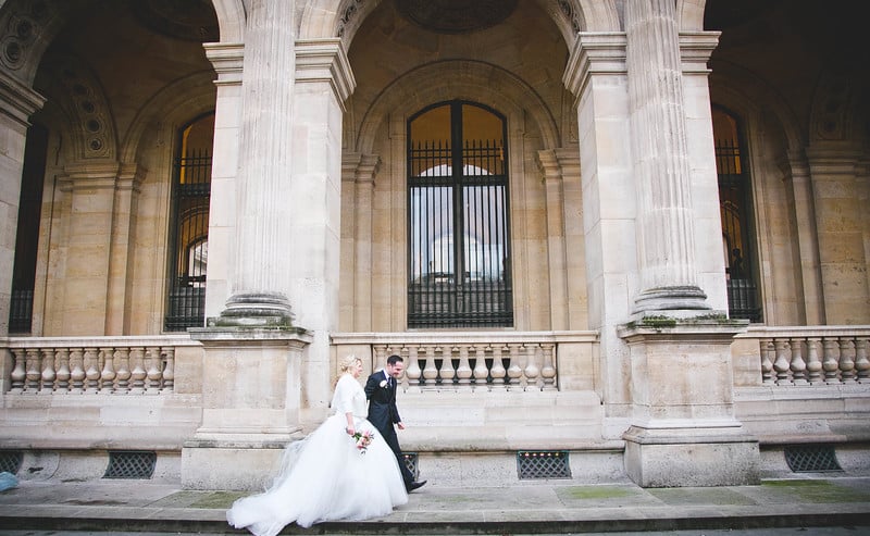 A couple during their winter elopement in Paris in front of the Louvre