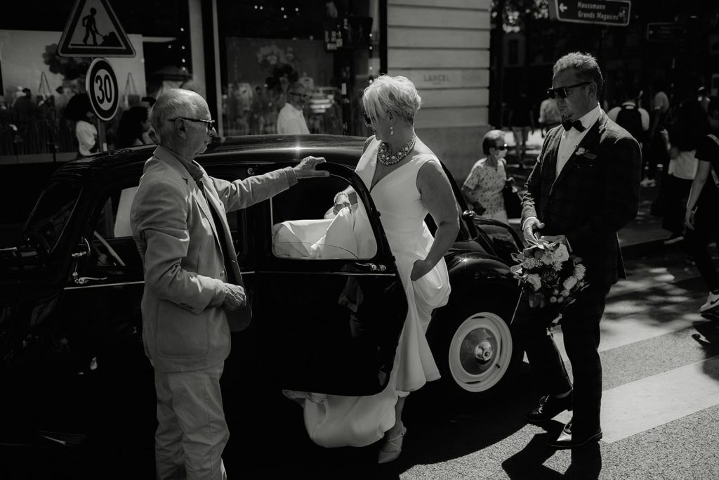 Group of wedding guests traveling together in private buses in Paris.