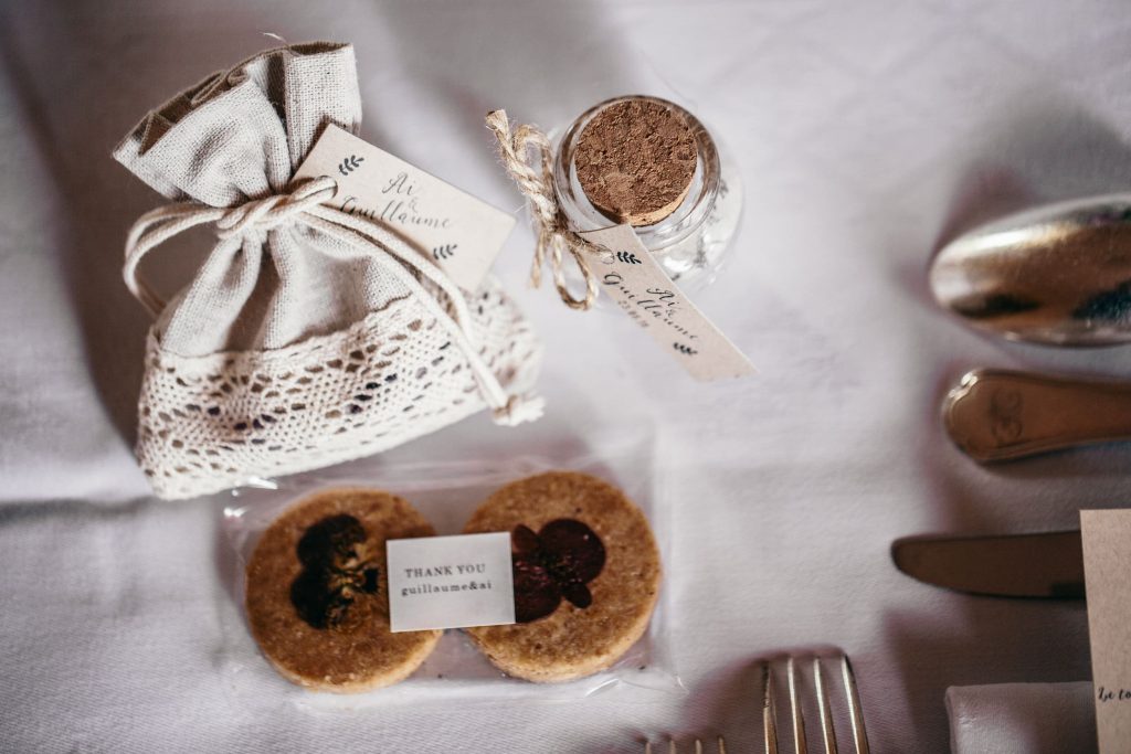 Personalized welcome bag with Paris map and macarons for wedding guests.
